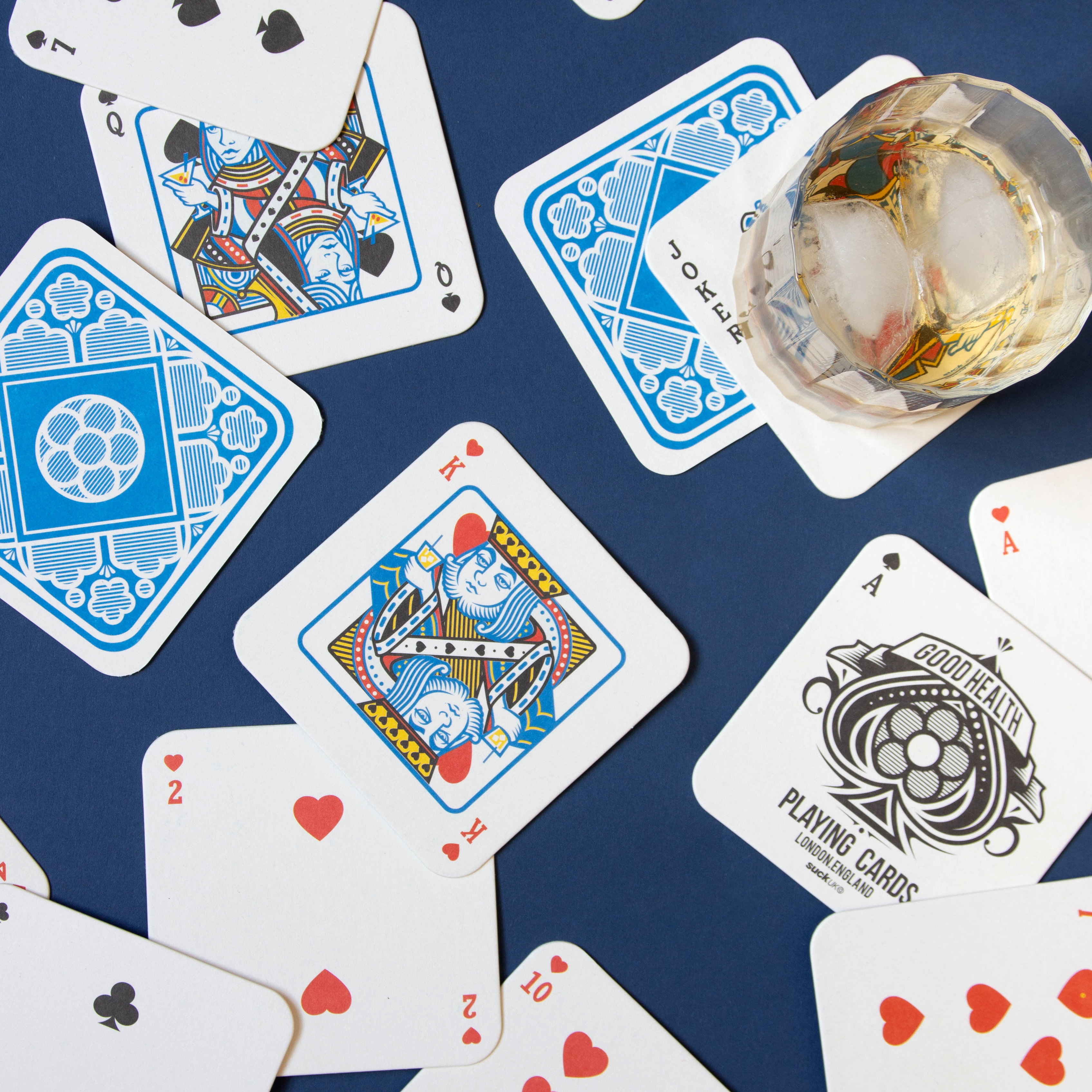 Playing Card Drink Mats Scattered On Table