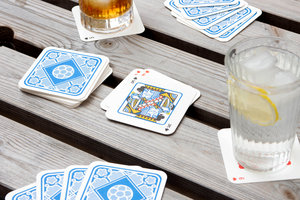 Playing cards with drink mats outside