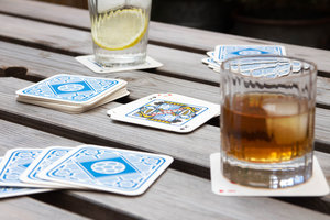 Playing cards at the pub with drink mats