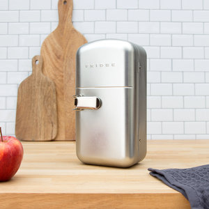 Fridge shaped food container closed on wooden worktop with tiles