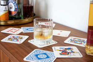 Glass of whiskey on playing card drink mats