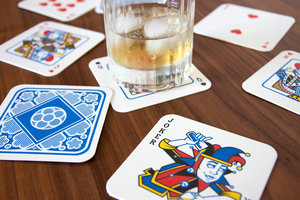 Paper beer mats printed with a deck of cards